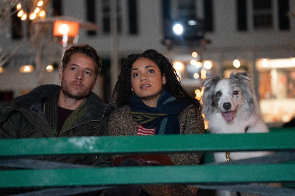 A man, a woman and a dog sit next to each other in a Netflix Christmas film.