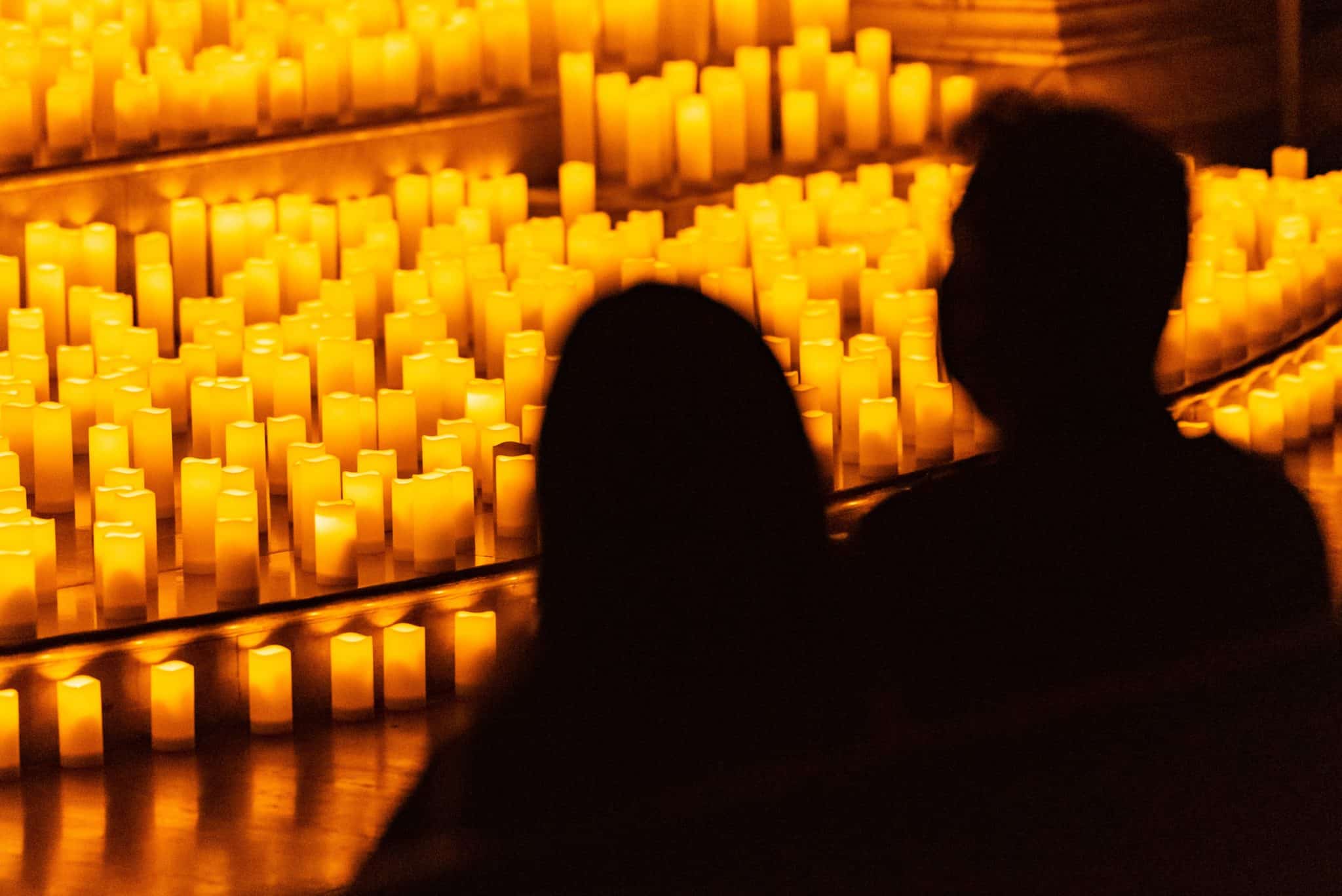 Silhouette of a couple watching a Candlelight concert. 