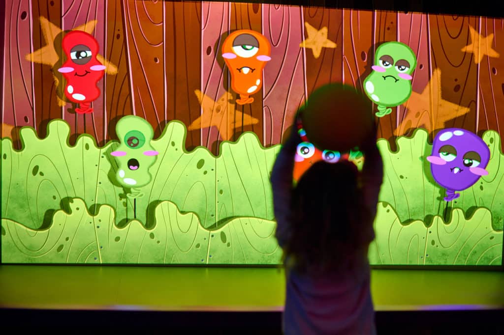 a child throwing a ball in a monster game at dreamland imaginarium
