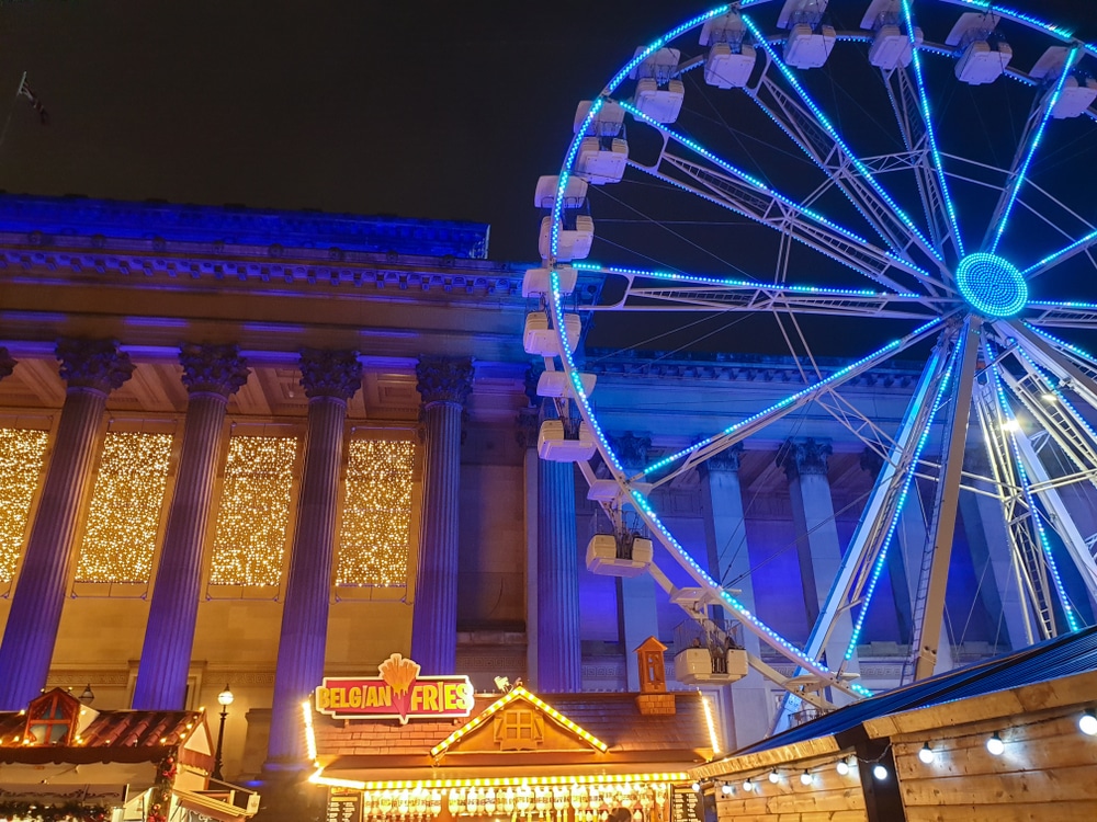 Christmas light shine beside a ferris wheel at Liverpool Christmas market.
