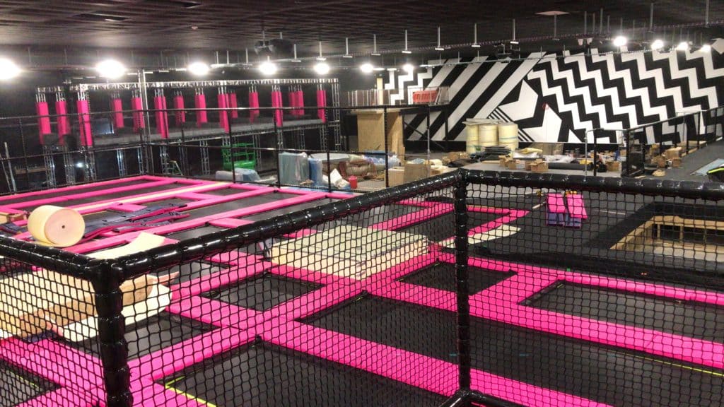 A platform of trampolines with pink cushioning at Jump Inc Liverpool.