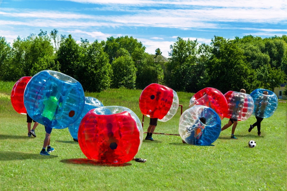 People run around a football pitch, surrounded by red, white and blue bubbles.