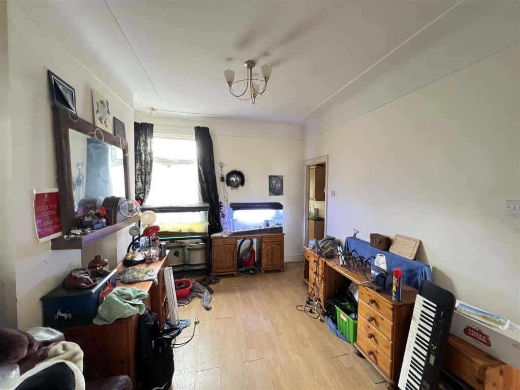 A room in a Liverpool house, filled with keyboards and cupboards.
