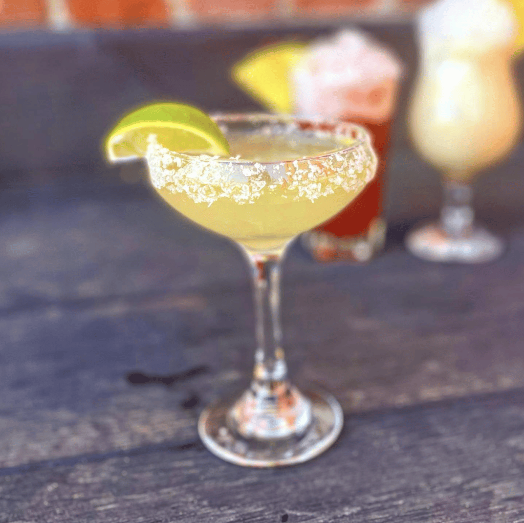 A yellow margarita, topped with a slice of lemon at What's Cooking. 