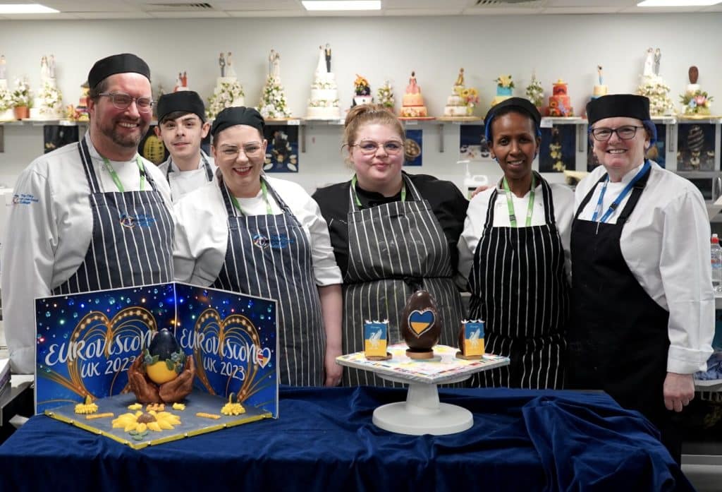 Trainee chefs at The Academy in Liverpol stand around Eurovision-inspired creations.
