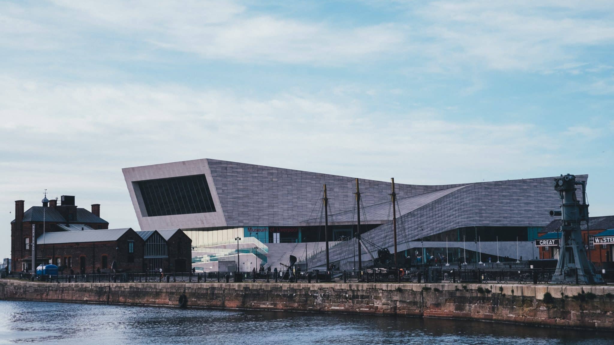 An image of The Museum of Liverpool taken from a distance showing the waterfront and a clear sky.