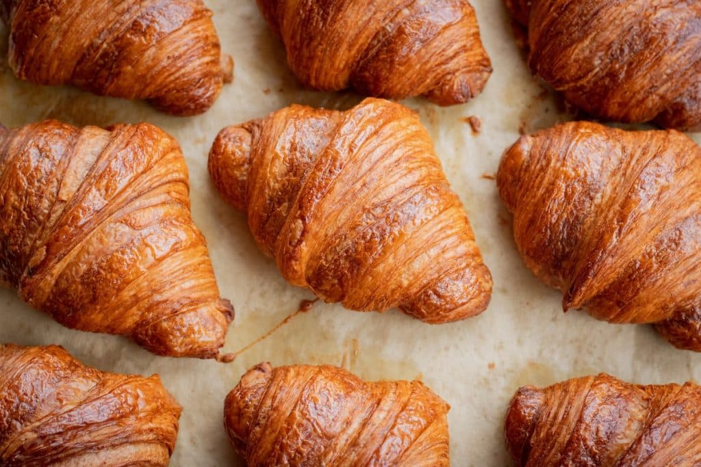 A whole tray of freshly baked croissants.